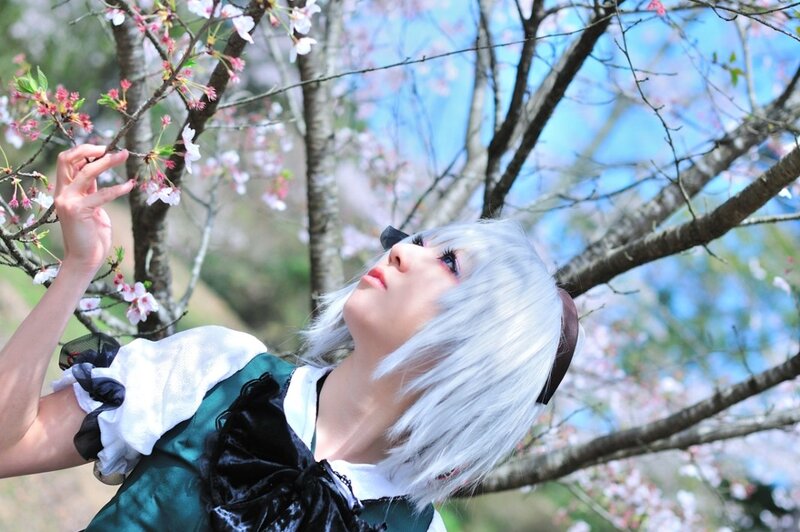 cosplayer under cherry blossoms