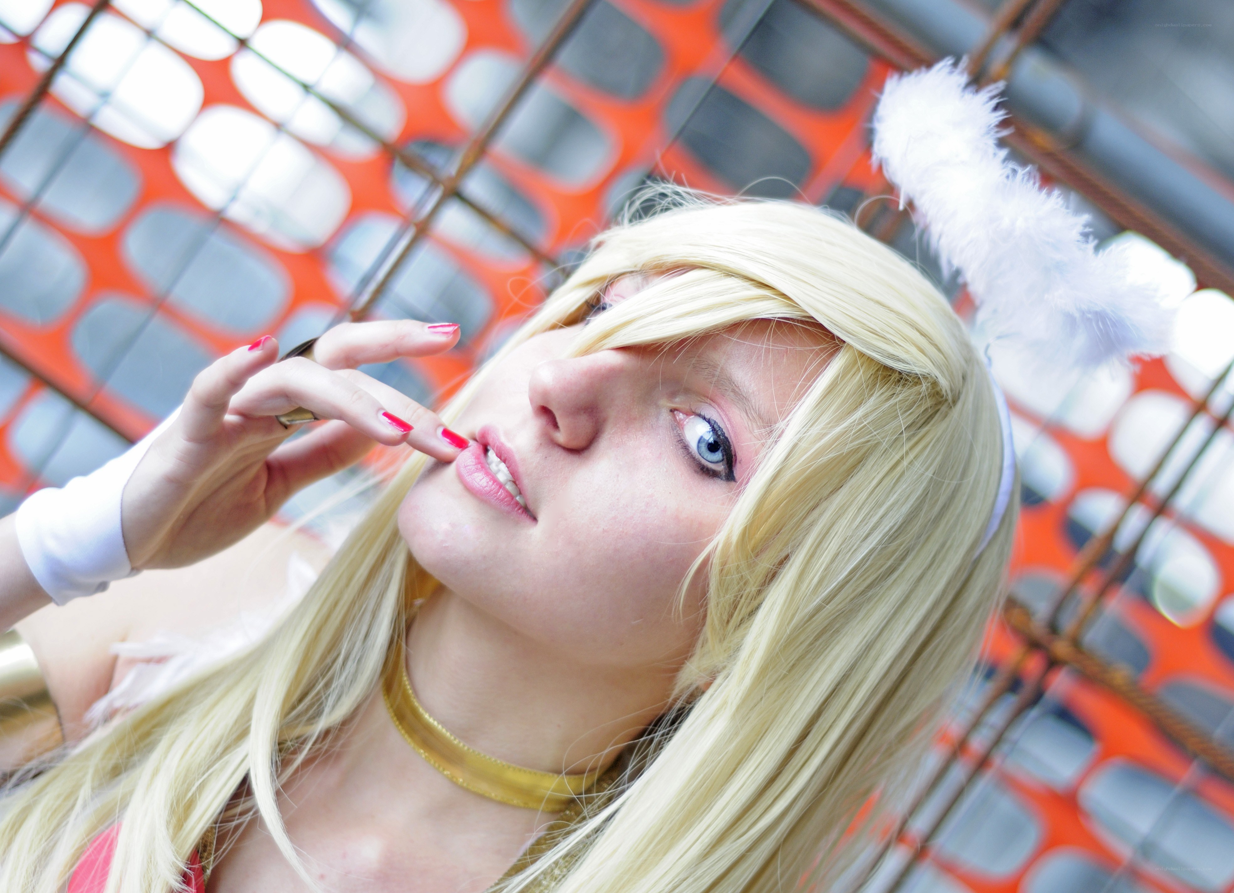 cosplayer with blonde wig and feather