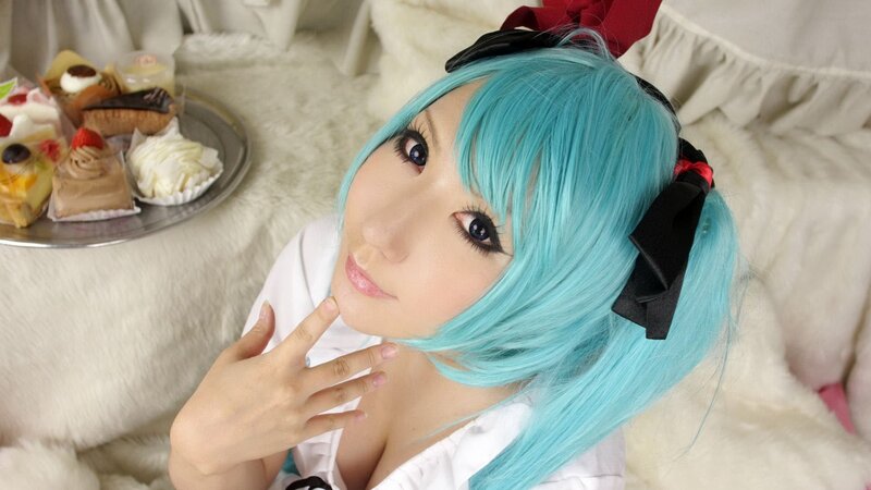 cosplayer with blue hair and pastries