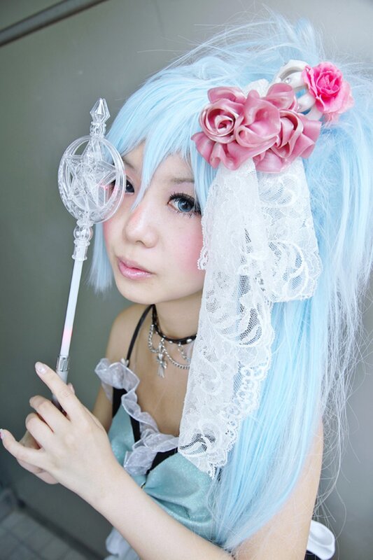 cosplayer with blue hair and wand