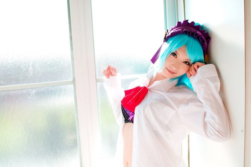 cosplayer with blue hair by window