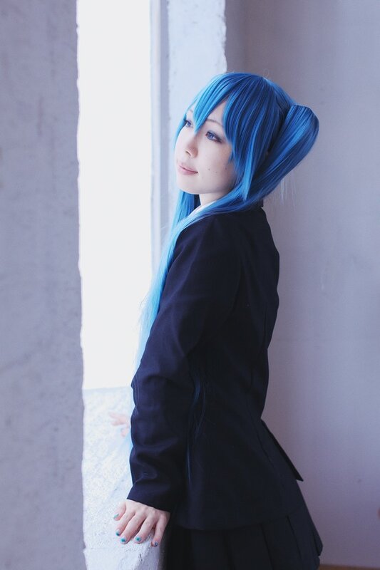 cosplayer with blue hair by window
