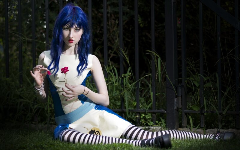 cosplayer with blue hair holding rose