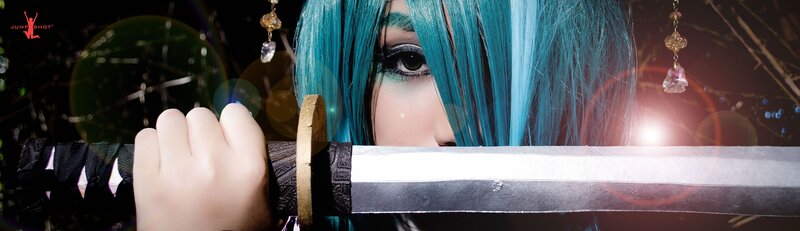 cosplayer with blue hair holding sword