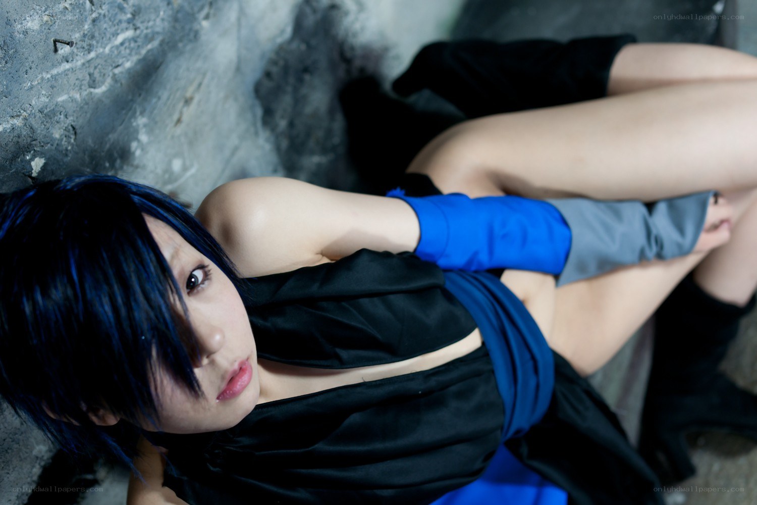 cosplayer with blue hair lying down