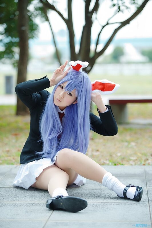 cosplayer with blue hair sitting