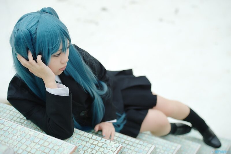cosplayer with blue hair sitting