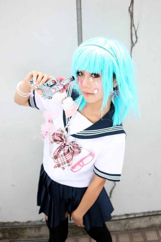 cosplayer with blue wig and toy gun