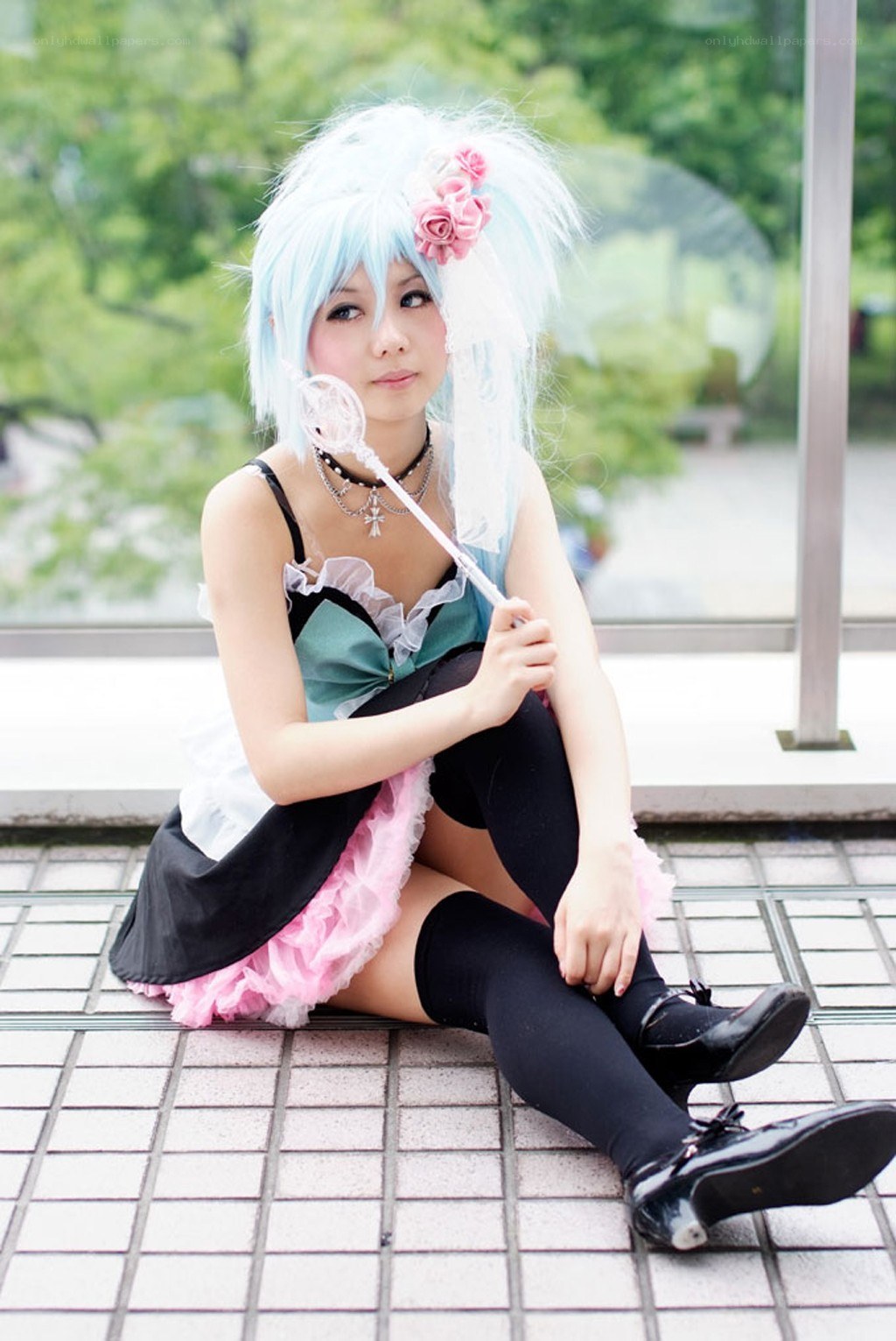 cosplayer with blue wig and wand