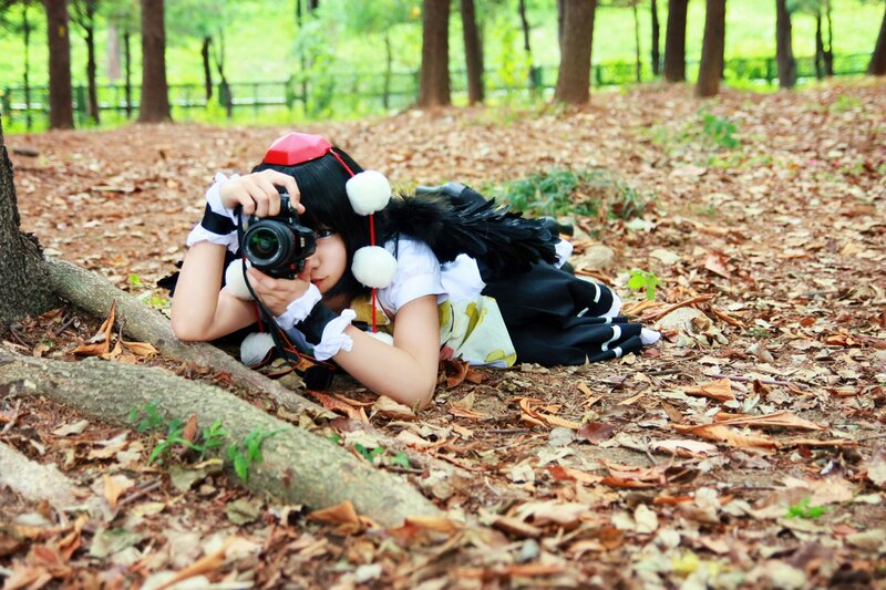cosplayer with camera in forest