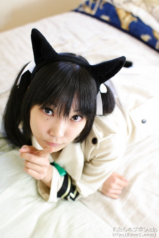 cosplayer with cat ears on bed