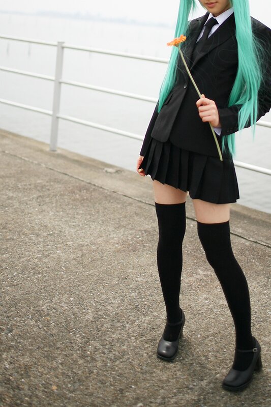 cosplayer with green hair holding flower