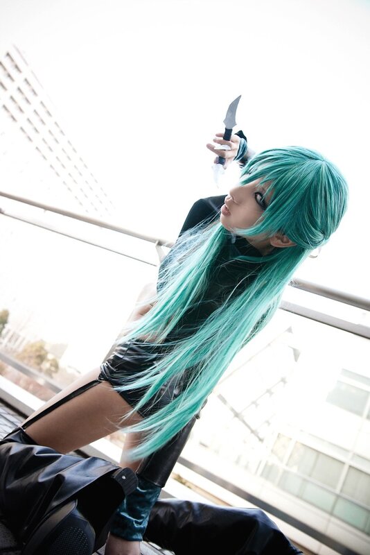 cosplayer with green hair holding knife