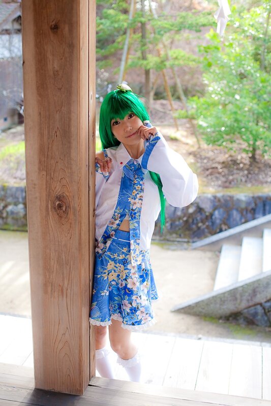 cosplayer with green hair in garden