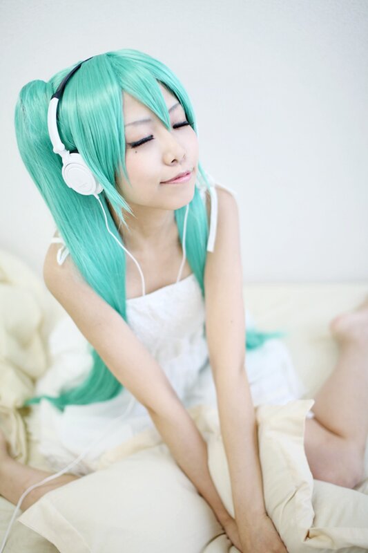 cosplayer with green hair listening to music