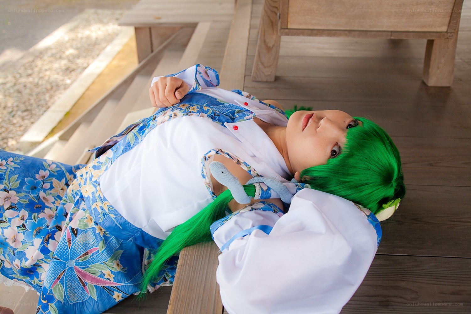 cosplayer with green hair lying down