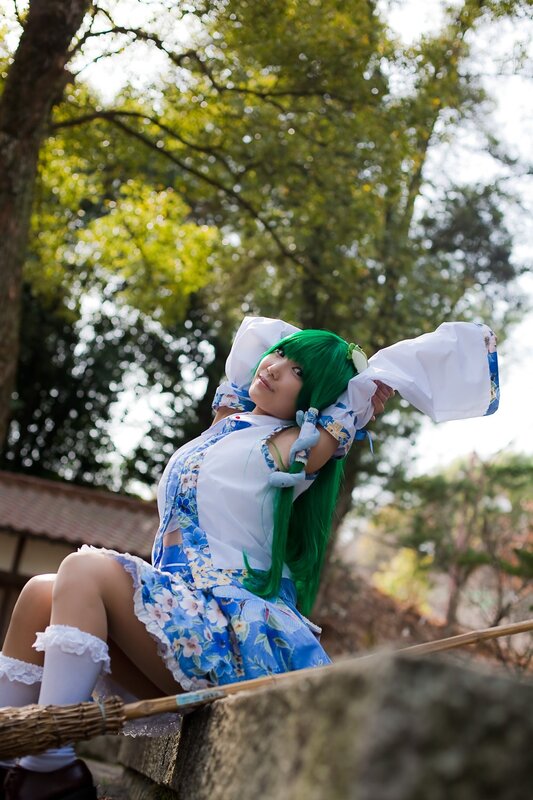 cosplayer with green hair outdoors