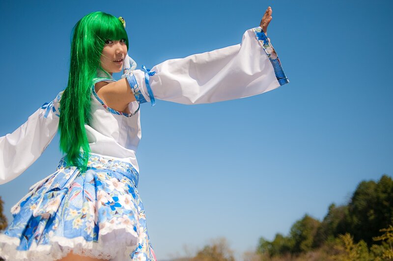 cosplayer with green hair outdoors