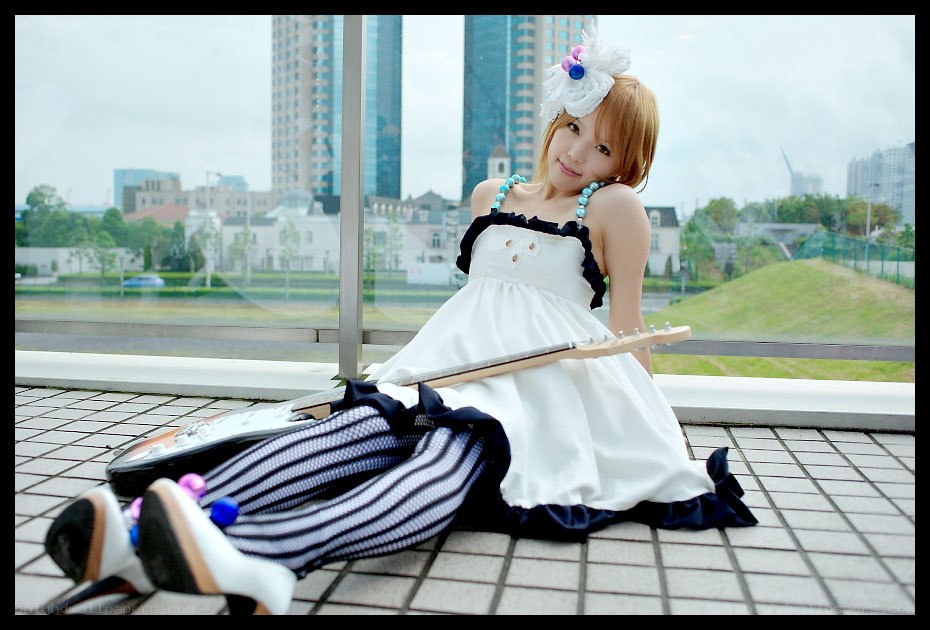 cosplayer with guitar on balcony