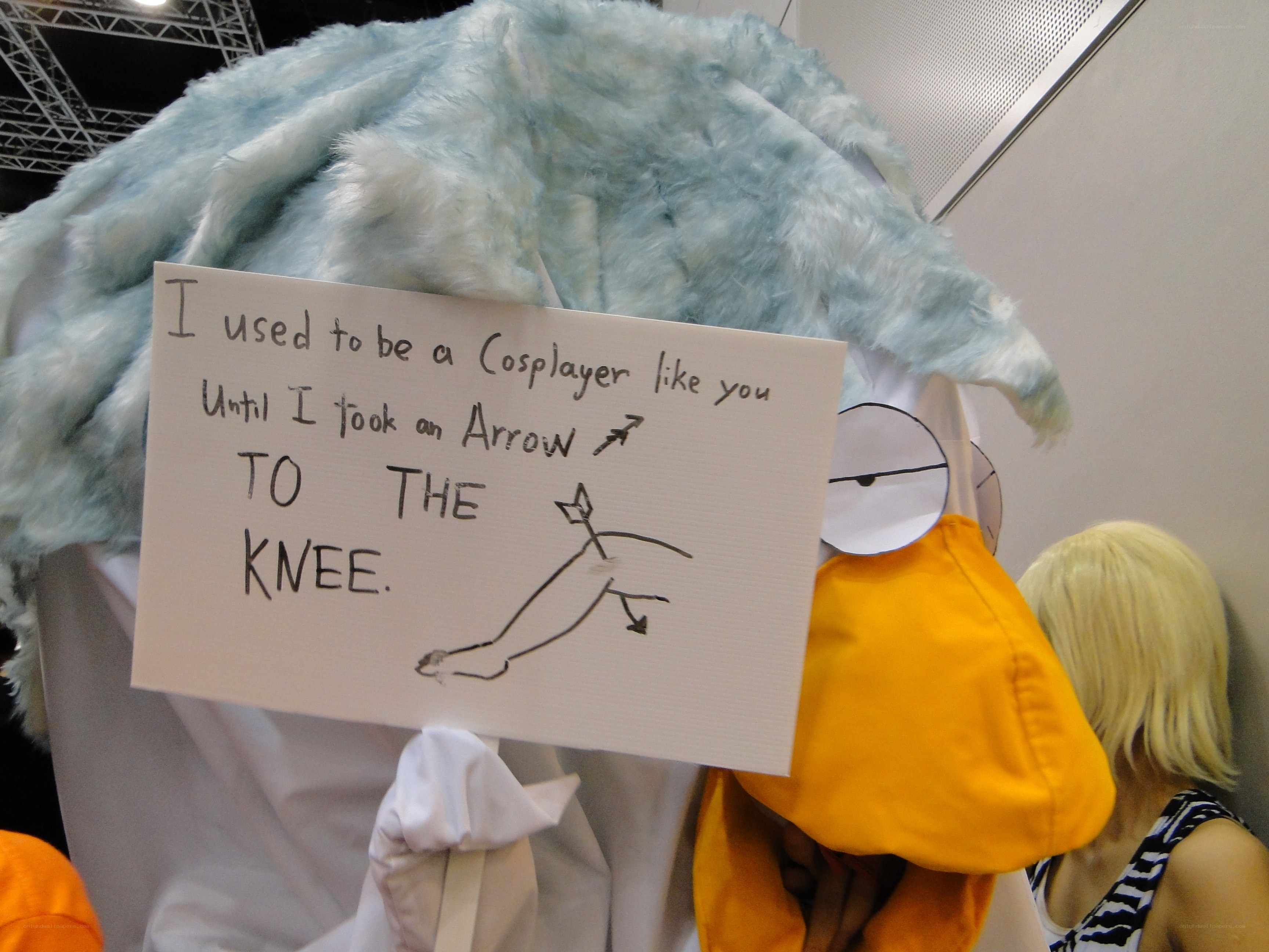 Cosplayer with humorous sign