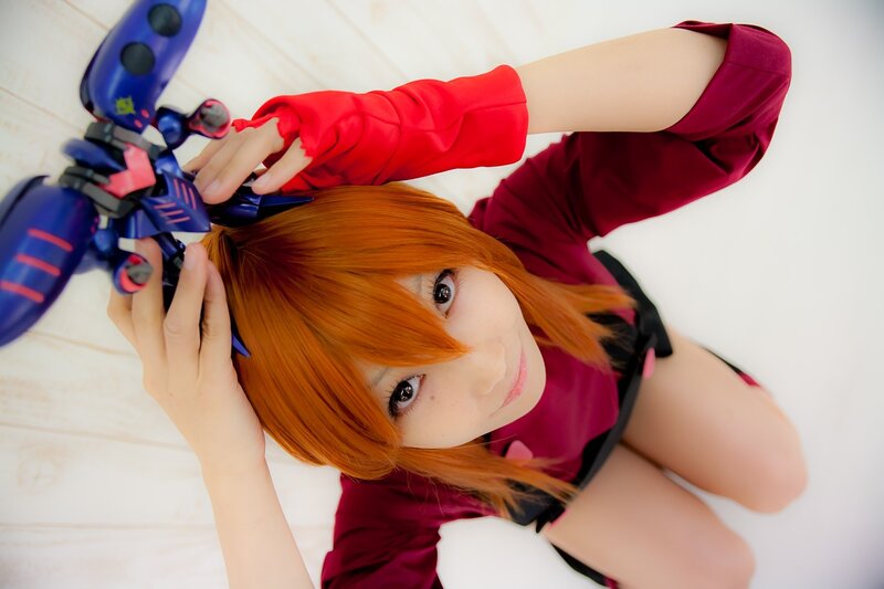 cosplayer with orange hair and toy