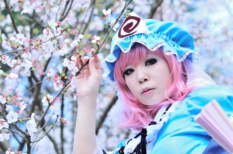 cosplayer with pink hair and cherry blossoms