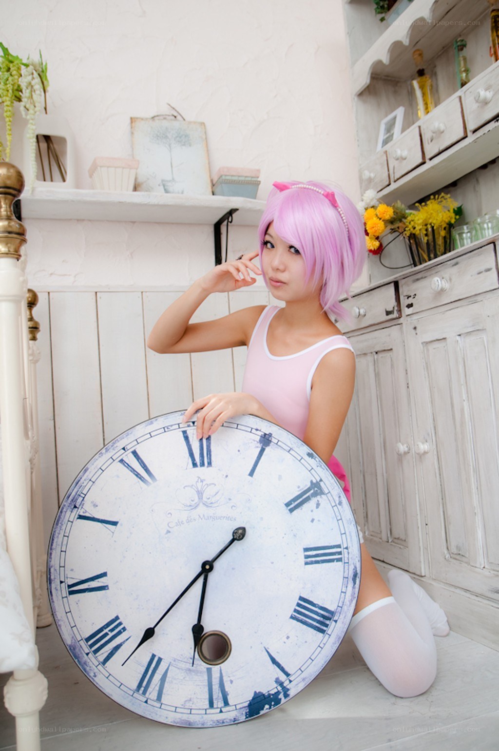 cosplayer with pink hair and clock