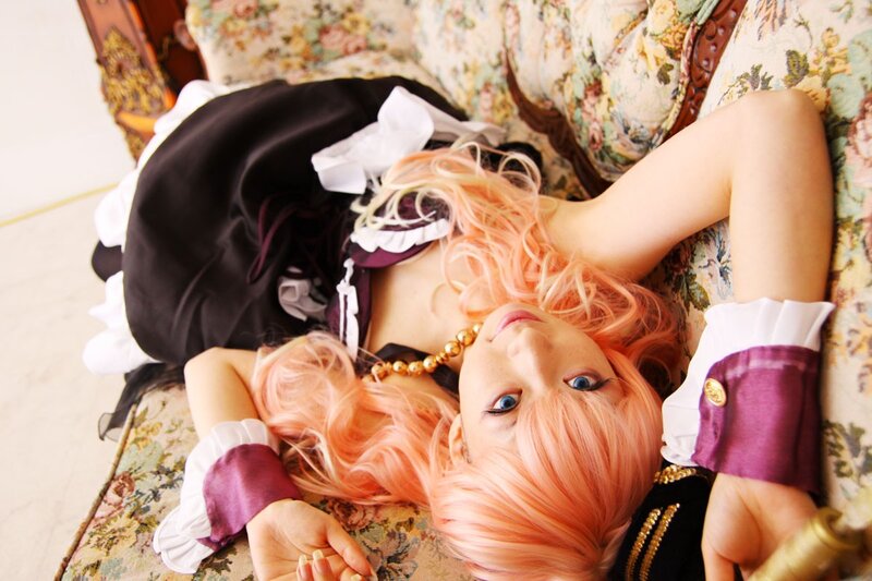 cosplayer with pink hair on couch