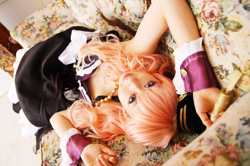 cosplayer with pink hair on floral couch