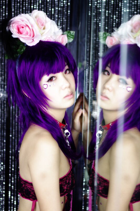 cosplayer with purple hair and flowers