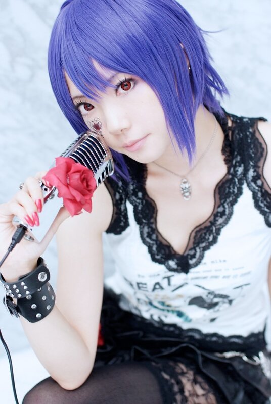 cosplayer with purple hair and microphone