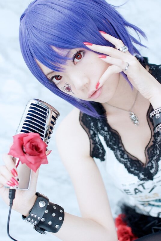 cosplayer with purple hair and microphone