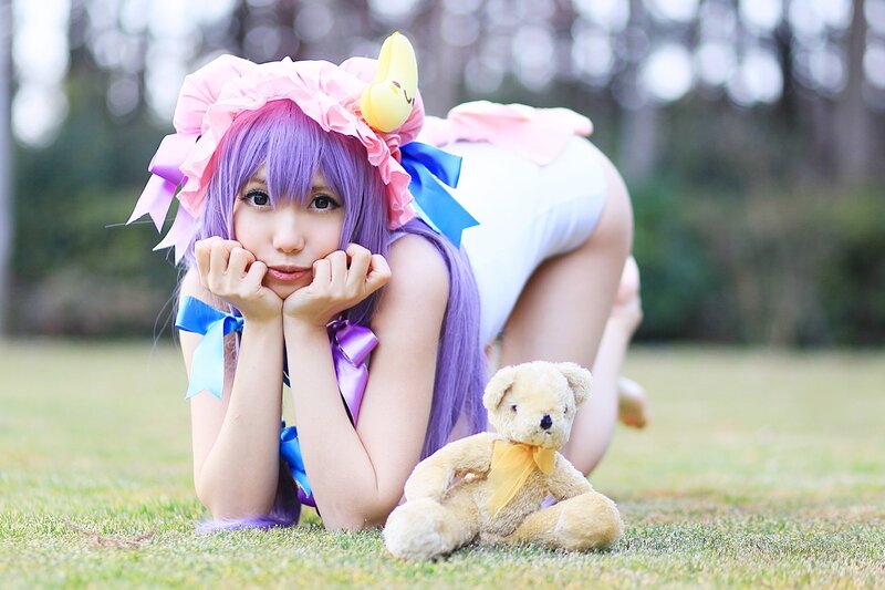 cosplayer with purple hair and teddy bear