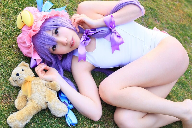 cosplayer with purple hair on grass