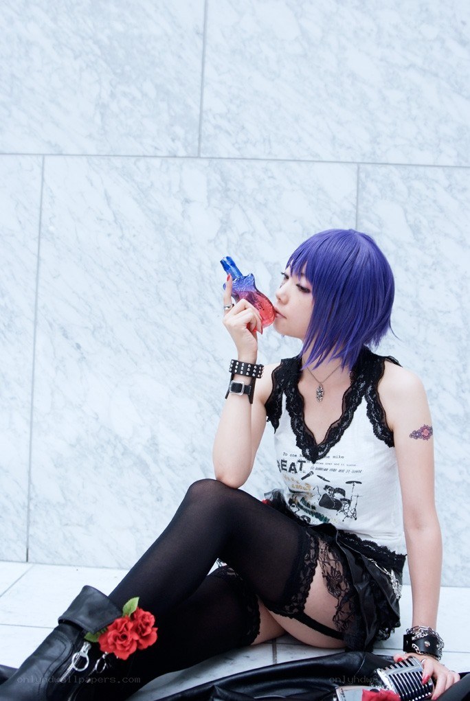 cosplayer with purple hair sitting