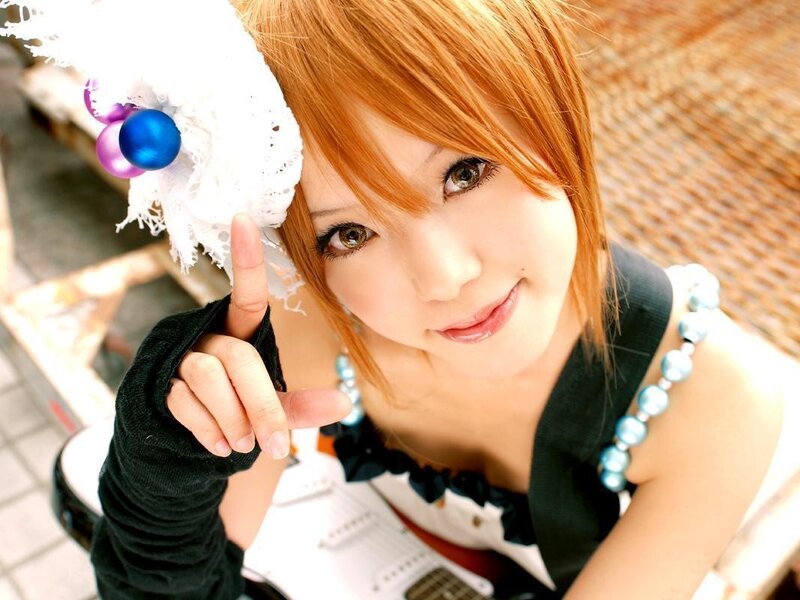 cosplayer with red hair and guitar