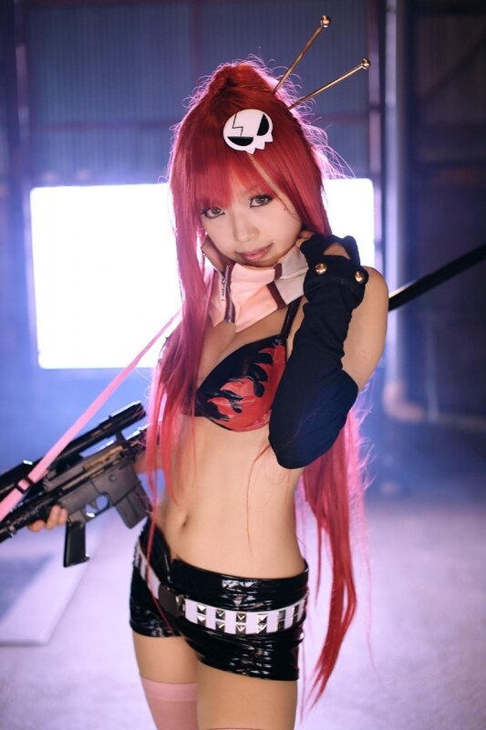 cosplayer with red hair and gun