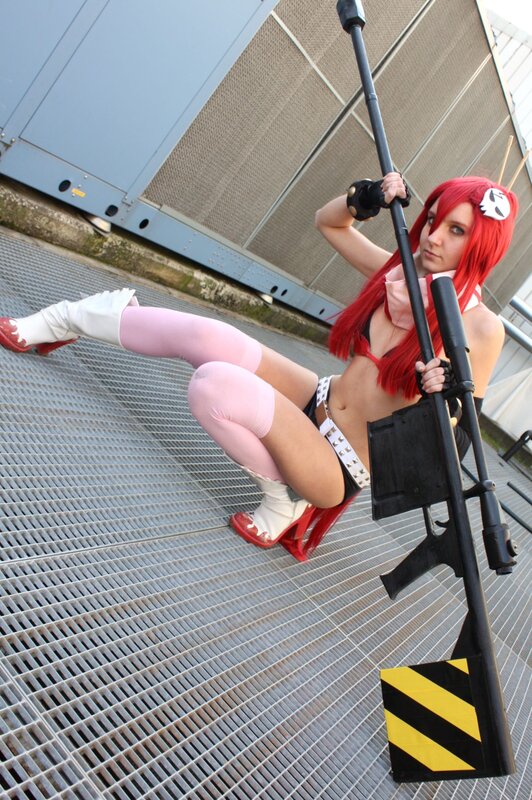 cosplayer with red hair and rifle