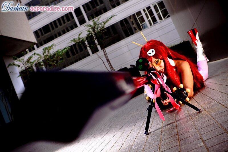 cosplayer with red hair and sniper rifle