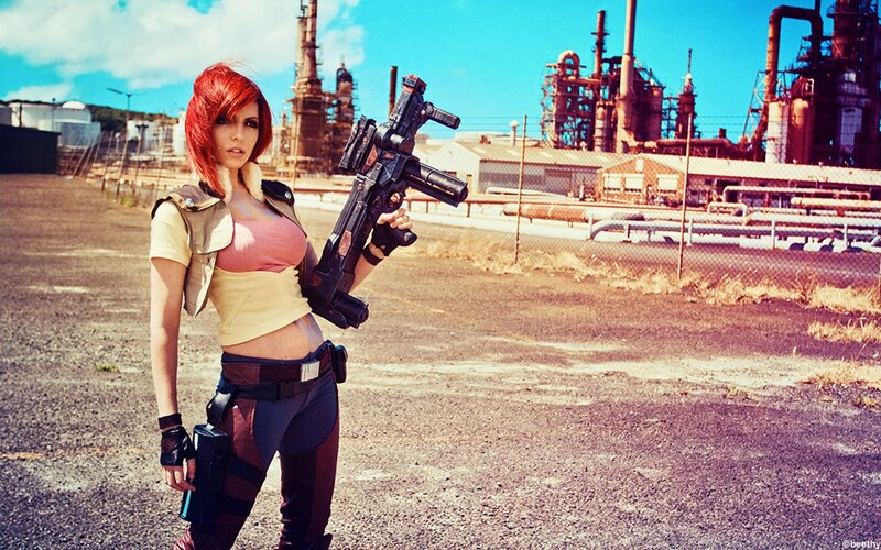 cosplayer with red hair and weapon