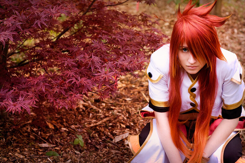 cosplayer with red hair in garden