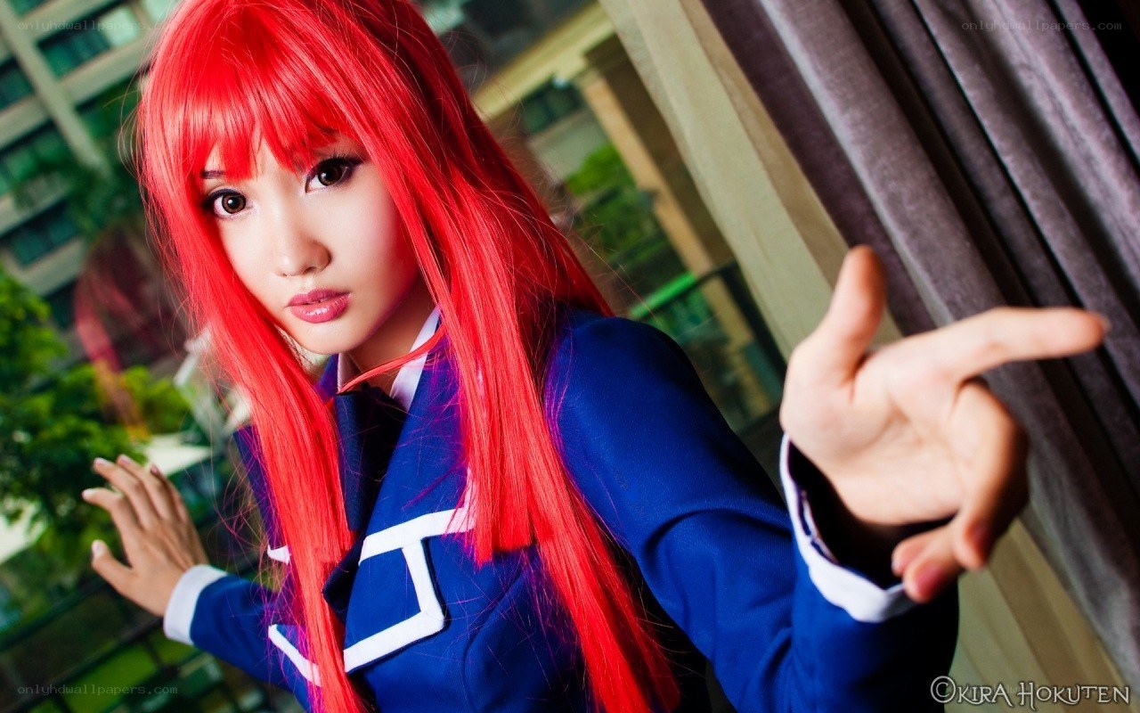 cosplayer with red hair pointing