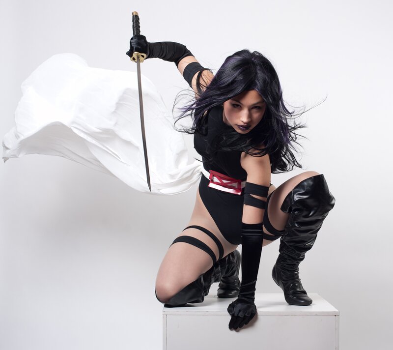 cosplayer with sword and cape