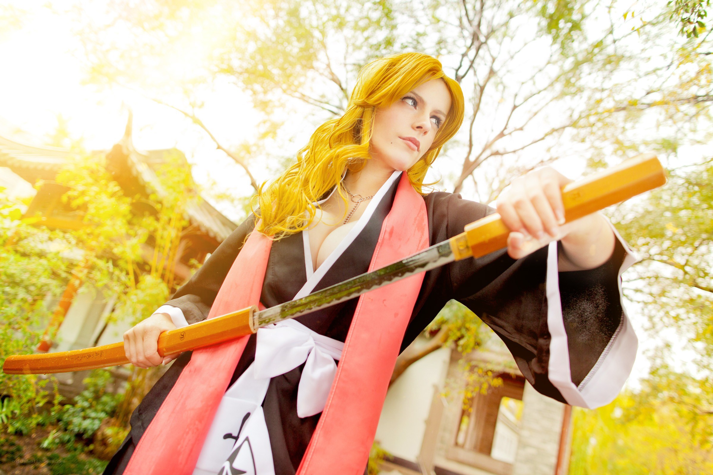 cosplayer with sword in garden