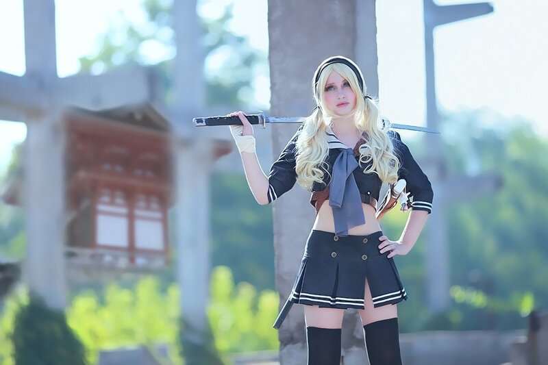 cosplayer with sword in school uniform