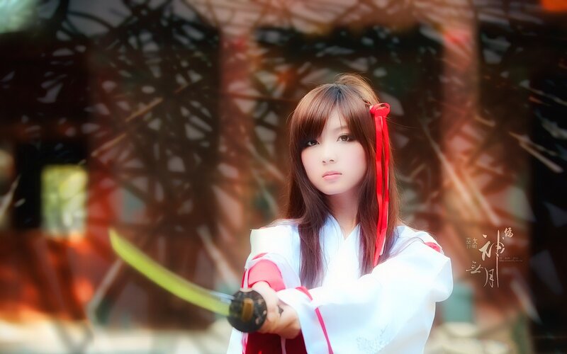 cosplayer with sword in traditional attire