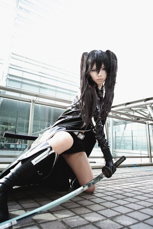 cosplayer with sword in urban setting