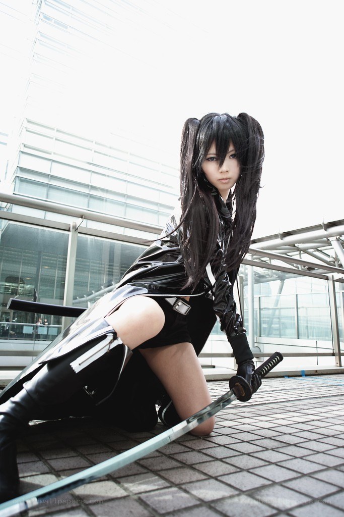 cosplayer with sword in urban setting