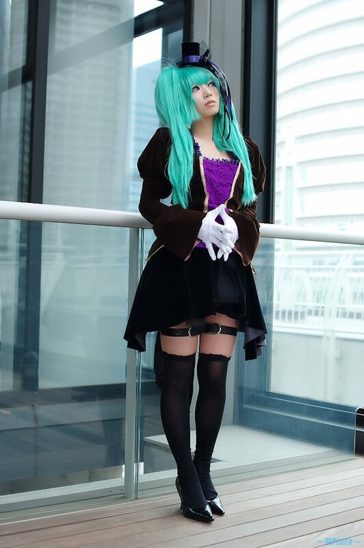 cosplayer with teal hair on balcony