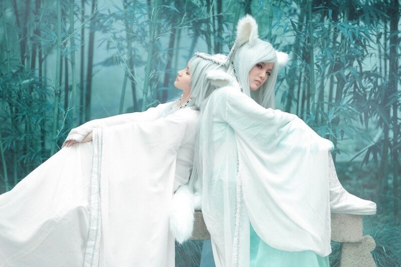 cosplayers in white fox costumes